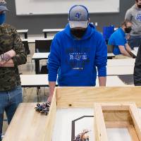 Students watch a robot move